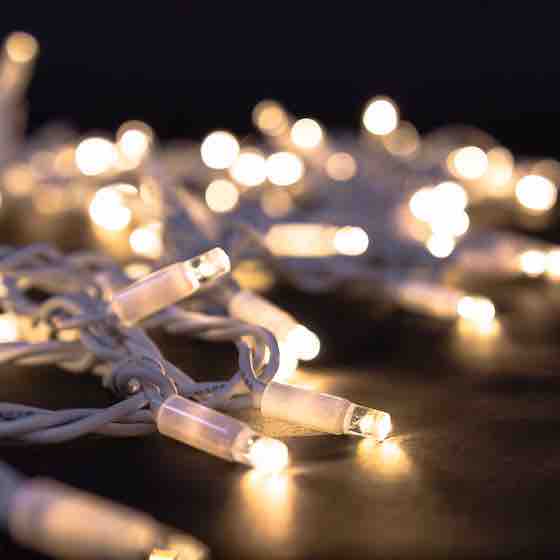 product shot of white fairy lights that are illuminated on a black background