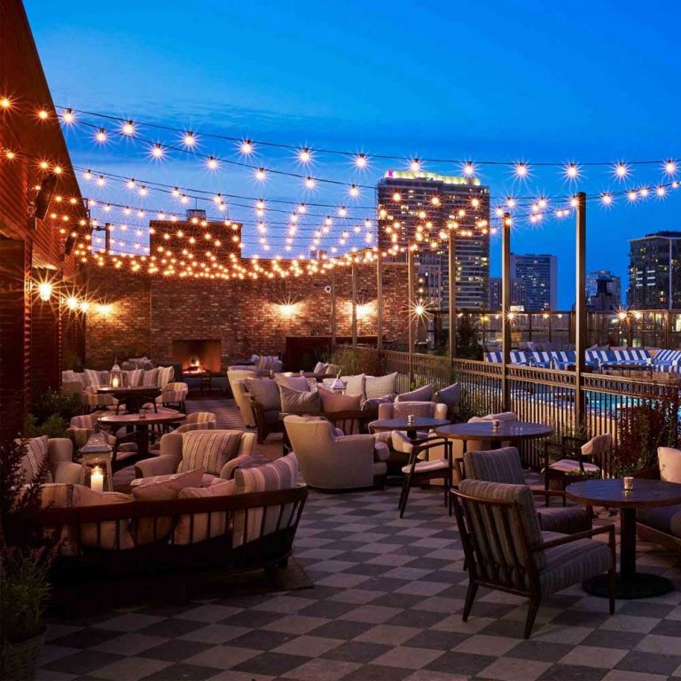 beautiful patio arrangement with glowing festoon lights at dusk