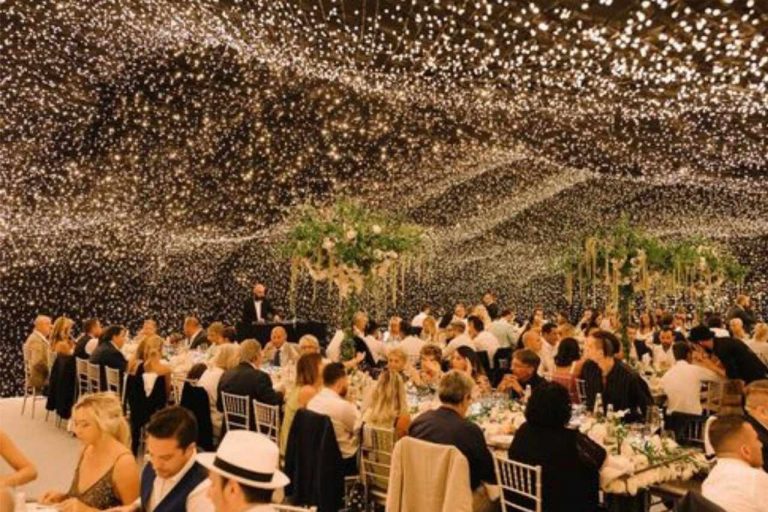 Pretty festoon lights illuminating a wedding.